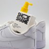 Shoe Shame Sweet feet 120 ml deodorising shoe spray next to a pair of sneakers