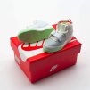 Close-up side profile of Air Yeezy 2 NRG mini sneaker keychain with strap detail