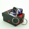 Close-up side profile of AJ1 “Court Purple” mini sneaker keychain with purple overlays