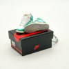 Close-up side profile of AJ1 “Turbo Green” mini sneaker keychain showing washed teal overlays