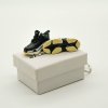 Close-up side profile of Triple S “Bred” mini sneaker keychain showing layered sole