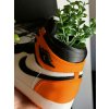 AJ1 “Shattered Backboard” sneaker planter styled on a shelf next to shoeboxes
