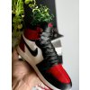 AJ1 “Bred Toe” sneaker planter styled on a shelf beside shoeboxes