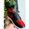 AJ1 “Bred” sneaker planter styled on a shelf next to shoeboxes