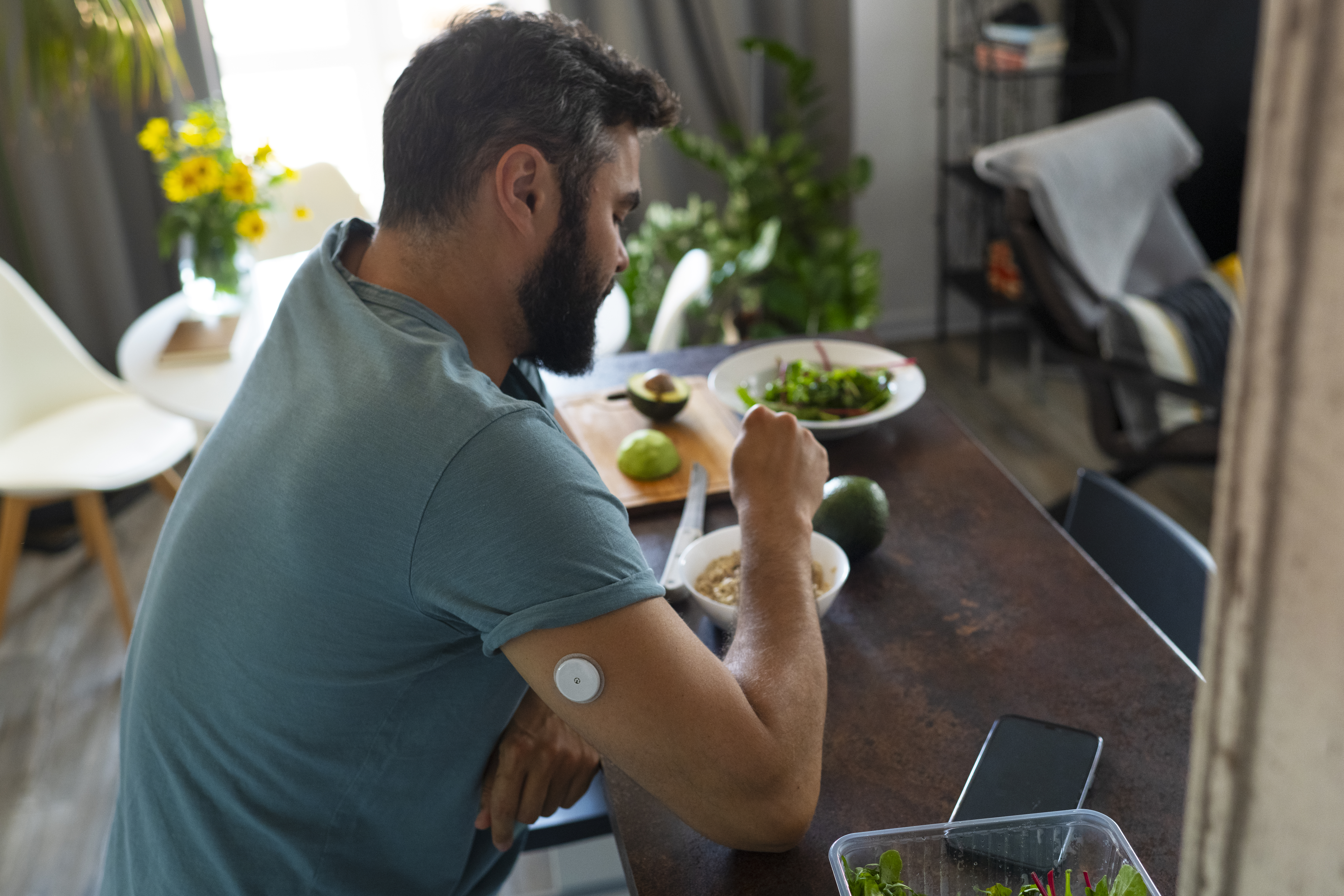 diabetic-man-with-glucose-patch-sensor-preparing-meal