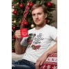 t shirt mockup of a man holding an 11 oz mug sitting in front of a christmas tree 30204