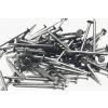 closeup shot metal nails white surface