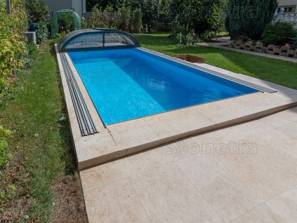 Pool deck pavers Marble Shells Beige along a lap pool, neat straight coping.