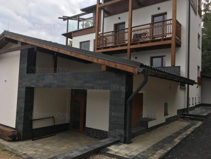 Stone wall cladding Slate Jack Black on exterior entrance columns adding strong contrast and modern style.