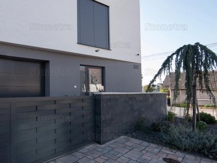 Stacked stone exterior Slate Ocean Black used on modern fence and facade creating elegant dark contrast.