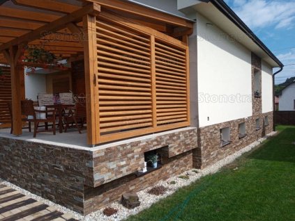 Stone siding Gneis Brown on exterior base wall combining warm brown tones with modern architecture.