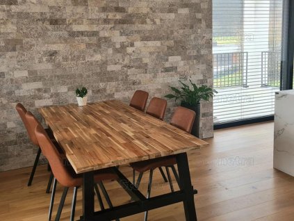 Stone accent wall Travertine Silver in modern dining room adding cool grey texture and natural contrast.