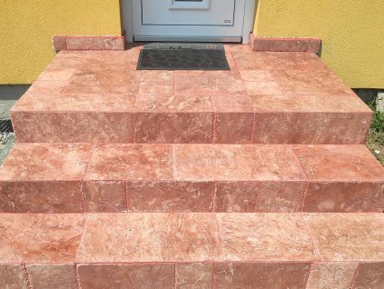 Stone tiles Travertine Red French pattern covering the front steps of a house with a warm red tone.