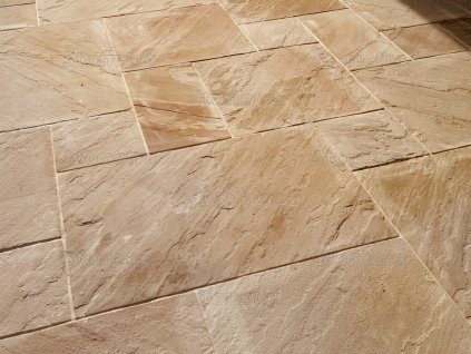 Outdoor pavers in Sandstone Modak show a neat surface with a utility hatch near the pool terrace.