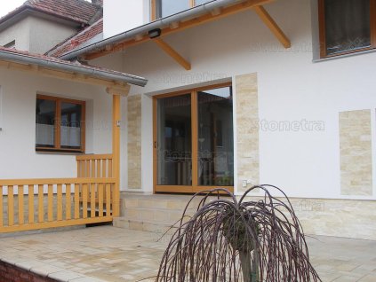 House entrance with cladding from natural stone Marble Yellow split face, stylish and durable natural stone wall