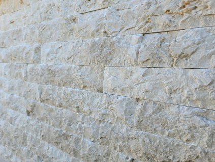 Close-up detail of natural stone Marble Rasol split face, natural textured surface of decorative stone wall