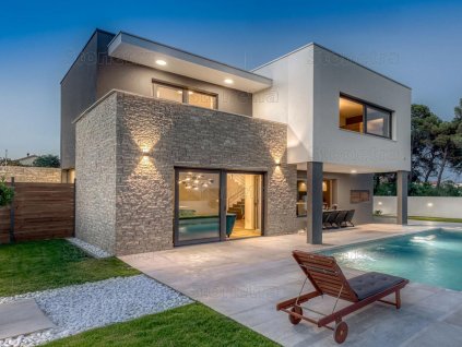 Modern house facade with natural stone cladding Limestone B4 Ben strips rock face