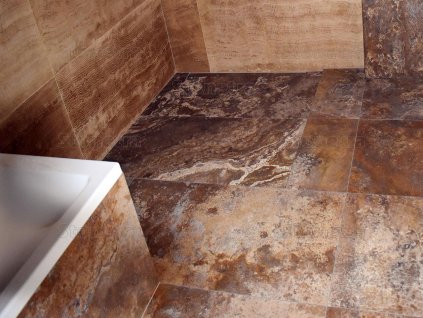 Bathroom with brown stone wall and floor in Travertine Zorro, filled and honed large-format tiles.
