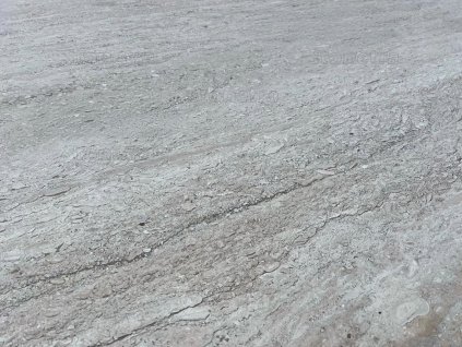 Smooth beige natural stone surface for interior cladding — Travertine Classic VC, filled and honed large-format tile.