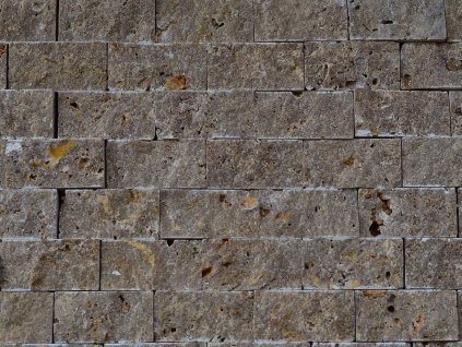 Close-up of dark Travertine Noche mosaic, 2.5×5 cm split face natural stone cladding.