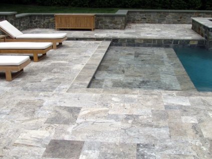 Pool deck pavers Travertine Silver French pattern surrounding a pool, full surface view.