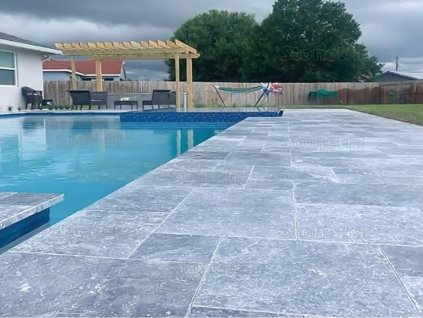 Pool deck pavers in Marble Dolphin, French pattern around a backyard pool; blue-gray natural stone surface in overall view.