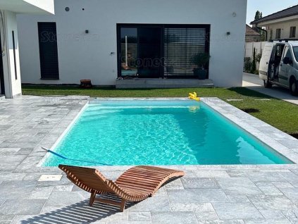Pool pavers in Marble Lagune French pattern used around a garden pool, full view with lounging area.