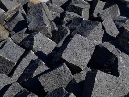 Driveway under construction with medium-format black basalt cobblestones - heavy-duty natural-stone surface.