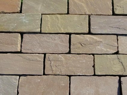 Close-up of Sandstone Camel castle pavers 20×10 cm, 4–6 cm thick, hand-cut edges — durable natural-stone courtyard paving.