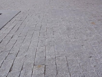 Laid surface of Granite Grey cobblestones 6×6×6 cm — 4 sides sawn, split top & bottom for slip resistance.