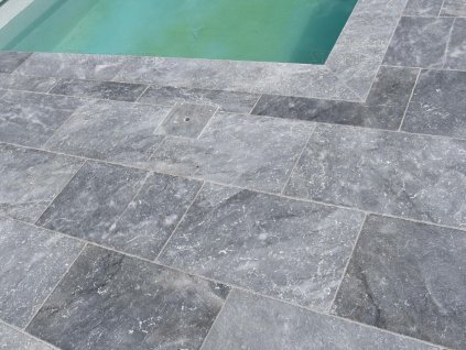 Pool deck pavers in Marble Dolphin 61×40.6×3 cm, close-up of the grey stone surround by the pool.