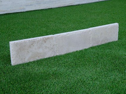 Mocha-toned natural stone edging with chiselled edge for elegant borders — Curbstone Travertine Mocca, chiselled edge.