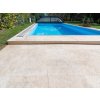 Pool pavers Marble Shells Beige framing a rectangular pool in a modern backyard, overall view.