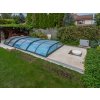 Garden patio slabs Marble Shells Beige surrounding a covered backyard pool, garden setting.