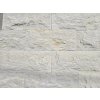 Stone wall cladding Marble Saturn Massive in light beige tones used on an exterior wall