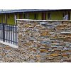 Stacked stone exterior Gneis Rusty Mond fence wall in warm brown and copper tones with natural texture.