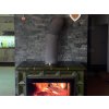 Stacked stone fireplace Gneis Blue-Green with deep slate tones creating natural interior atmosphere.