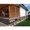 Stone siding Gneis Brown on exterior base wall combining warm brown tones with modern architecture.
