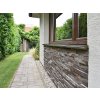 Stone siding Andesite Gray-Brown used on exterior wall creating durable and elegant natural surface.