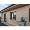 Stone wall cladding Travertine Classic on modern house facade with light beige natural stone texture.
