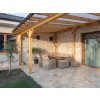 Stone bricks Travertine Classic creating warm natural look on terrace walls beneath wooden pergola.