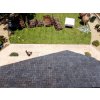 Stone walkway pavers of Travertine Classic forming a border between lawn and paved area.