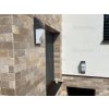 Stacked stone exterior Travertine Noce applied to house facade combining rustic character and elegance.