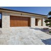 Driveway pavers in Travertine Classic leading to a garage, small-format 30×15 pattern.