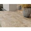 Garden pavers Travertine Noche 30×15×3 cm creating a small backyard terrace beside the house with earthy color variation.
