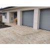 Driveway pavers Travertine Noche 30×15×3 cm installed on the approach in front of a garage, durable natural stone surface.