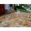 Travertine Gold patio pavers creating a cozy seating area in the yard.
