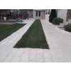 Stone walkway pavers in Marble Saturn, linear path with a grass strip in a modern garden, walkway.