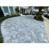 Driveway pavers with Marble Dolphin following a curved approach near garden beds.