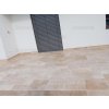 Stone floor Travertine Classic French pattern installed in an outdoor sitting area with warm beige tones.